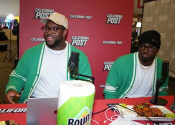 Kobie Turner and Byron Young at the California Post booth at the Super Bowl LX media center.