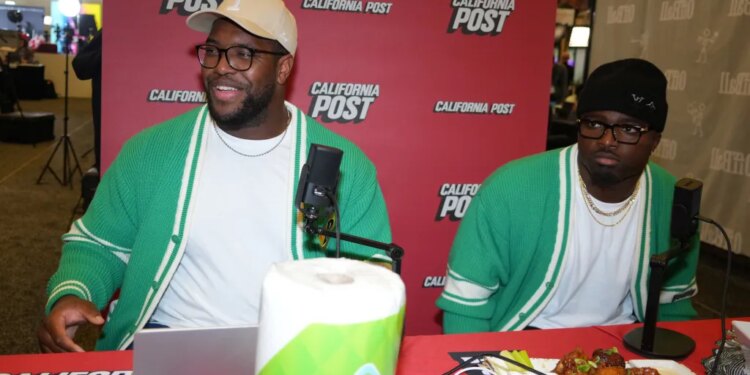 Kobie Turner and Byron Young at the California Post booth at the Super Bowl LX media center.