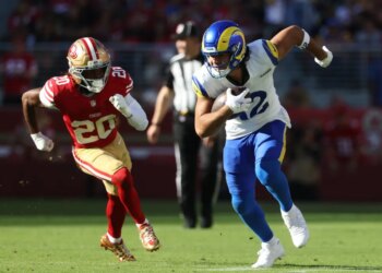 Los Angeles Rams wide receiver Puka Nacua (12) running while San Francisco 49ers cornerback Upton Stout (20) chases him from behind.