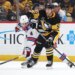 Pittsburgh Penguins Egor Chinakhov (59) moves the puck against New York Rangers Braden Schneider (4).