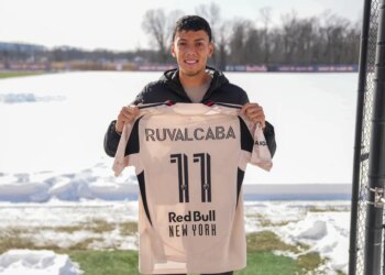 Red Bull New York player Ruvalcaba holds up his number 11 jersey on a snowy field.