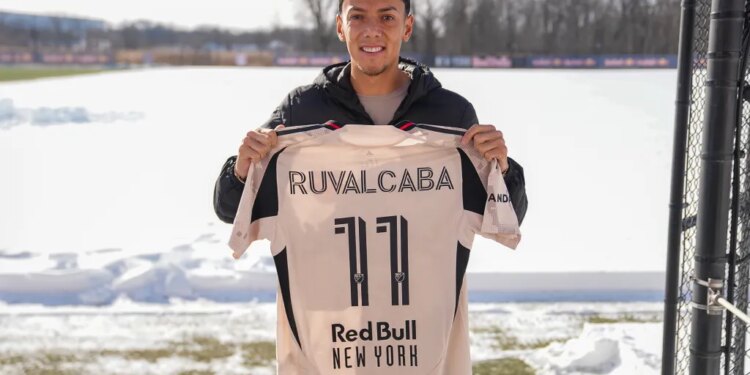 Red Bull New York player Ruvalcaba holds up his number 11 jersey on a snowy field.