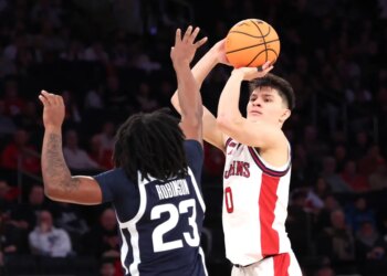 St. John's Red Storm guard Dylan Darling #0 puts up a shot as Butler Bulldogs guard Azavier Robinson #23 defends during the second half. The St. John's Red Storm defeated the Butler Bulldogs 92-70.