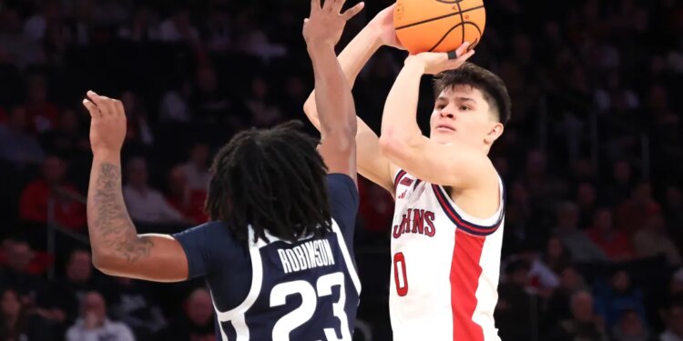 St. John's Red Storm guard Dylan Darling #0 puts up a shot as Butler Bulldogs guard Azavier Robinson #23 defends during the second half. The St. John's Red Storm defeated the Butler Bulldogs 92-70.