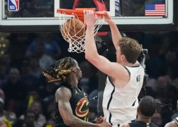 Brooklyn Nets forward Danny Wolf (2) dunks next to Cleveland Cavaliers guard Keon Ellis, left, in the first half of an NBA basketball game in Cleveland, Thursday, Feb. 19, 2026.