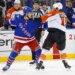 New York Rangers center Sam Carrick (39) and Philadelphia Flyers right wing Garnet Hathaway (19) scuffle during a game.