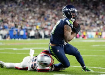 Jaxon Smith-Njigba makes a catch past Marcus Jones during Super Bowl 60.