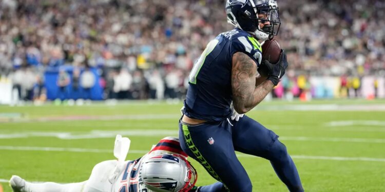 Jaxon Smith-Njigba makes a catch past Marcus Jones during Super Bowl 60.