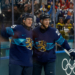 Anton Lundell and Eetu Luostarinen of Finland celebrating a goal during a men's ice hockey game.