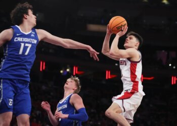 St. John's guard Dylan Darling shoots over Creighton forward Kerem Konan (17) during the second half of an NCAA college basketball game.