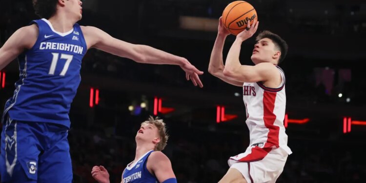 St. John's guard Dylan Darling shoots over Creighton forward Kerem Konan (17) during the second half of an NCAA college basketball game.