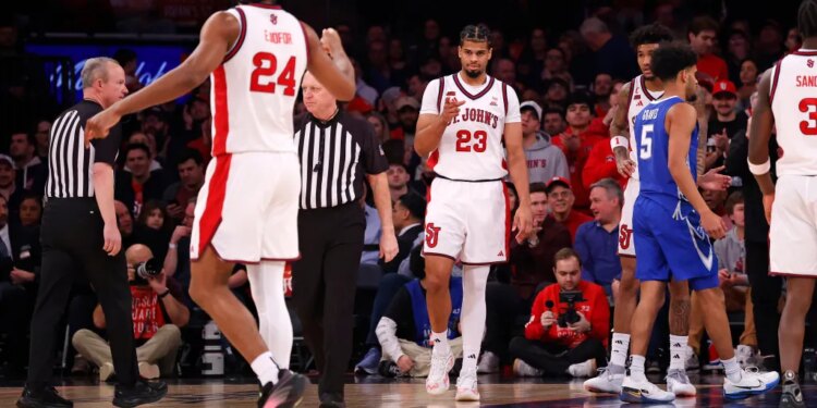Bryce Hopkins and Zuby Ejiofor of the St. John's Red Storm basketball team celebrate during a game against the Creighton Bluejays.