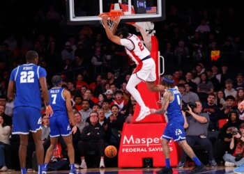 St. John's Red Storm player Bryce Hopkins #23 slams the ball into the hoop.