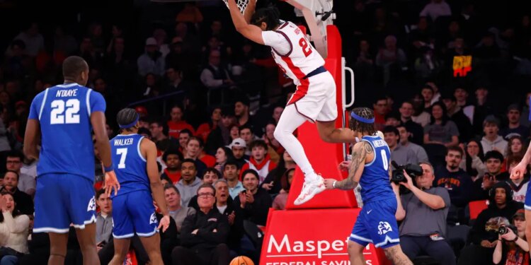 St. John's Red Storm player Bryce Hopkins #23 slams the ball into the hoop.