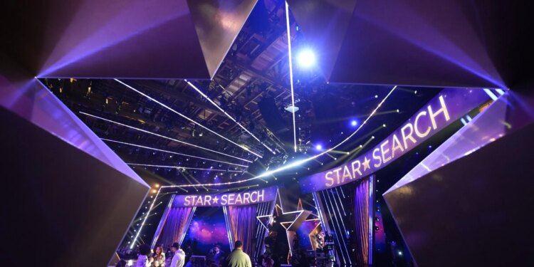 A photo of a studio, shot through a large star standing on the ground.