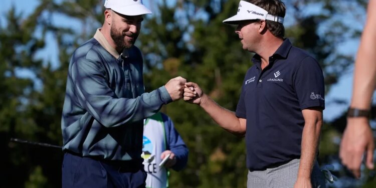 Travis Kelce and Keith Mitchell fist-bumping on a golf course.