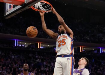 New York Knicks guard Mikal Bridges dunking the ball during a game against the Los Angeles Lakers.