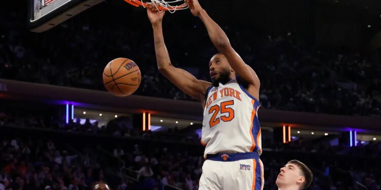 New York Knicks guard Mikal Bridges dunking the ball during a game against the Los Angeles Lakers.