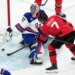 Connor Hellebuyck (37) uses his stick to block a shot by Canada's Devon Toews (7) during the third period of the men's ice hockey gold medal game at the 2026 Winter Olympics in Milan, Italy, Sunday, Feb. 22, 2026.
