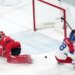 Czechia's Ondrej Palat (18) scores a goal against Canada goalkeeper Jordan Binnington (50) during the third period of a men's ice hockey quarterfinal on Feb. 18, 2026, at the Winter Olympics.