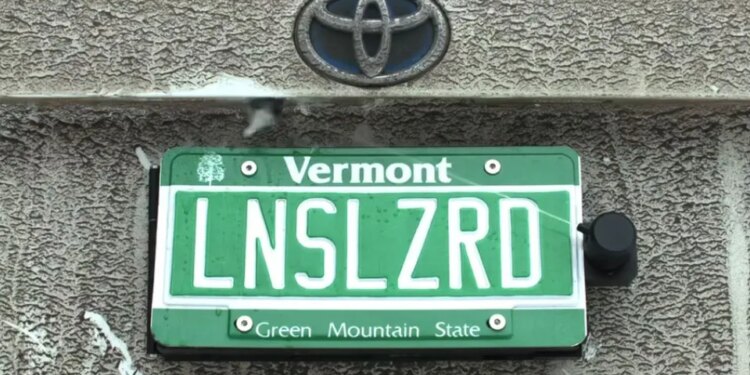 This backup camera cleaner hides behind your license plate