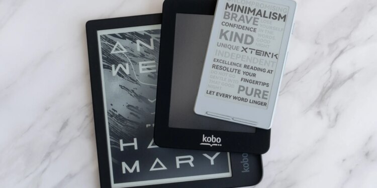 The Xteink X4 e-reader on top of two smaller Kobo e-readers.