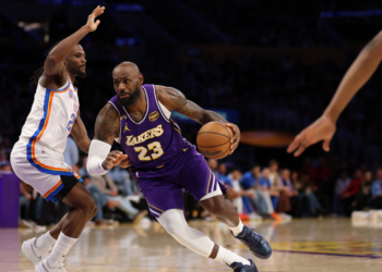 LeBron James of the Los Angeles Lakers dribbles the ball against an Oklahoma City Thunder player.