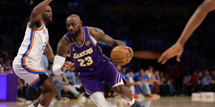 LeBron James of the Los Angeles Lakers dribbles the ball against an Oklahoma City Thunder player.
