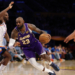 LeBron James of the Los Angeles Lakers dribbles the ball against an Oklahoma City Thunder player.