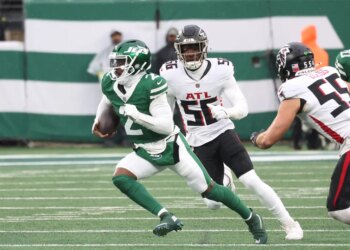 New York Jets quarterback Tyrod Taylor (2) runs the ball as Atlanta Falcons defensive end Leonard Floyd (56) gives chase during the first half when the New York Jets played the Atlanta Falcons Sunday, November 30, 2025 at MetLife Stadium in East Rutherford, NJ.