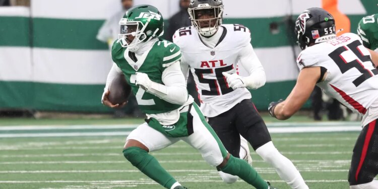 New York Jets quarterback Tyrod Taylor (2) runs the ball as Atlanta Falcons defensive end Leonard Floyd (56) gives chase during the first half when the New York Jets played the Atlanta Falcons Sunday, November 30, 2025 at MetLife Stadium in East Rutherford, NJ.