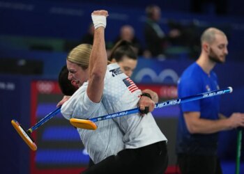 United States' Korey Dropkin and Cory Thiesse embrace after their semi-finals round of the mixed doubles curling match against Italy, at the 2026 Winter Olympics, in Cortina d'Ampezzo, Italy, Monday, Feb. 9, 2026.