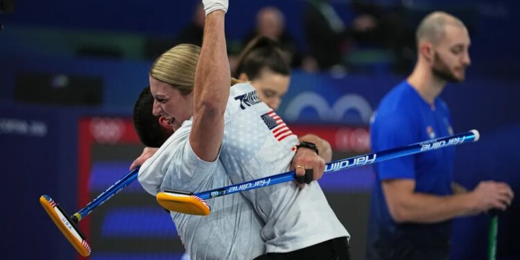 United States' Korey Dropkin and Cory Thiesse embrace after their semi-finals round of the mixed doubles curling match against Italy, at the 2026 Winter Olympics, in Cortina d'Ampezzo, Italy, Monday, Feb. 9, 2026.