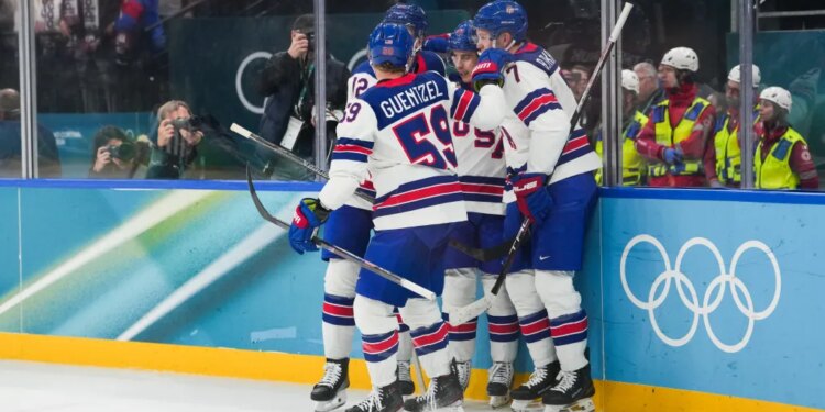 Jack Hughes (86) of the United States celebrates with teammates after scoring a goal during the second period against Slovakia in a men's ice hockey semifinal during the Milano Cortina 2026 Olympic Winter Games at Milano Santagiulia Ice Hockey Arena.