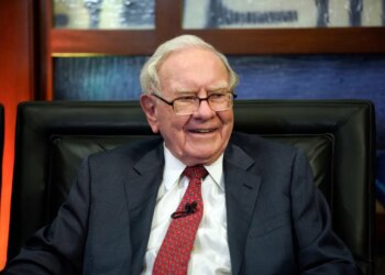 Warren Buffett smiles during an interview.