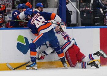 New York Islanders' Matthew Schaefer (48) checks New York Rangers' Brennan Othmann (78) during the first period of an NHL hockey game Wednesday, Jan. 28, 2026.