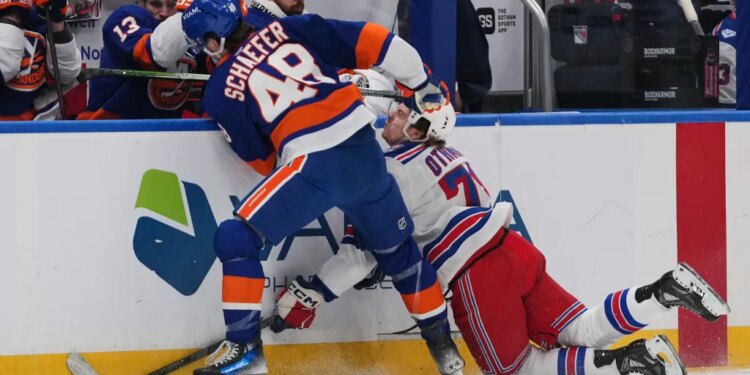 New York Islanders' Matthew Schaefer (48) checks New York Rangers' Brennan Othmann (78) during the first period of an NHL hockey game Wednesday, Jan. 28, 2026.