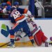 New York Islanders' Matthew Schaefer (48) checks New York Rangers' Brennan Othmann (78) during the first period of an NHL hockey game Wednesday, Jan. 28, 2026.
