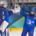 Italian ice hockey players Gabriella Frances Durante and Laura Fortino celebrate a goal during a game.