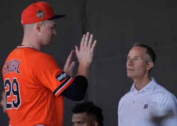 Detroit Tigers owner Chris Ilitch speaks with pitcher Tarik Skubal during spring training workouts.