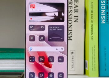 Photo of the Xiaomi Leica Leitzphone on a bookshelf, showing the home screen with monochrome widgets