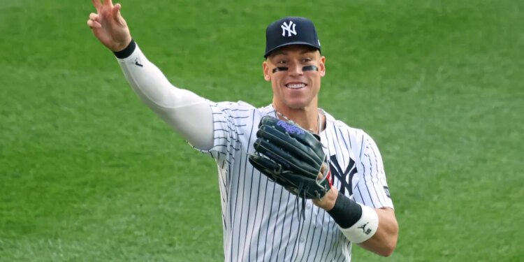 Aaron Judge throws a ball to fan during a Yankees home game against the Orioles last season.