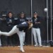 New York Yankees pitcher Carlos Lagrange #84 throwing during spring training with four coaches observing in the background.