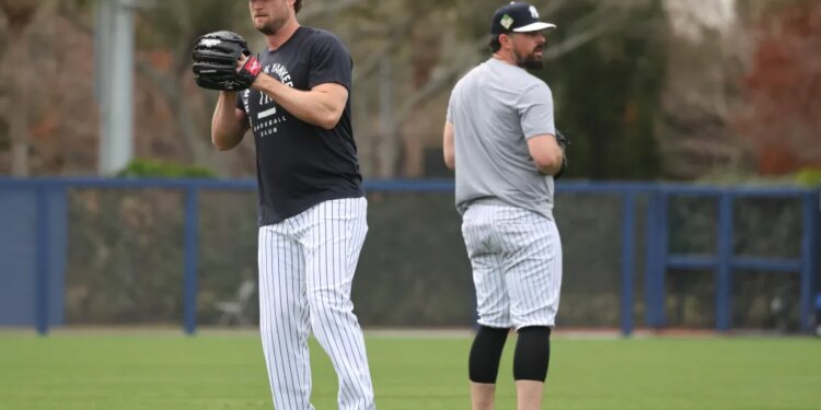 New York Yankees pitchers Gerrit Cole and Carlos Rodón throwing on a back field at Steinbrenner Field.