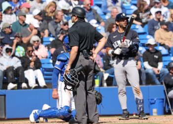 home plate umpire Tom Fornarola makes an announcement as New York Yankees shortstop José Caballero #72, challenged the call which was overturned