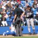 home plate umpire Tom Fornarola makes an announcement as New York Yankees shortstop José Caballero #72, challenged the call which was overturned