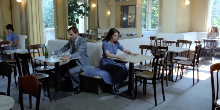 Sam Neill and Isabelle Adjani seated in a cafe facing away from each other in 1981’s Possession.