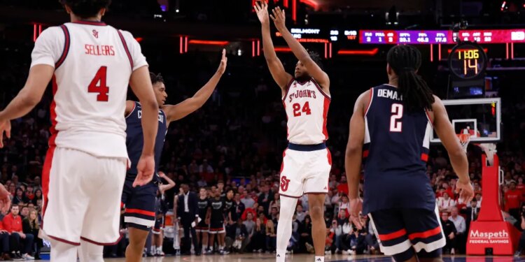 St. John's Red Storm forward Zuby Ejiofor (24) shoots a three-point shot.