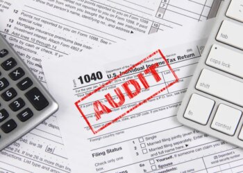 Online tax filing - federal 1040 form with computer keyboard and calculator