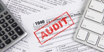 Online tax filing - federal 1040 form with computer keyboard and calculator